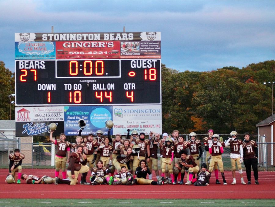 Team photo under the scoreboard lights